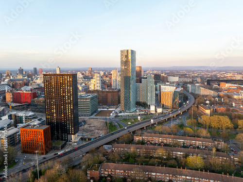 Fototapeta Naklejka Na Ścianę i Meble -  Aerial image of Mancunian Way at Hulme, Manchester with the city skyline at Sunset. 