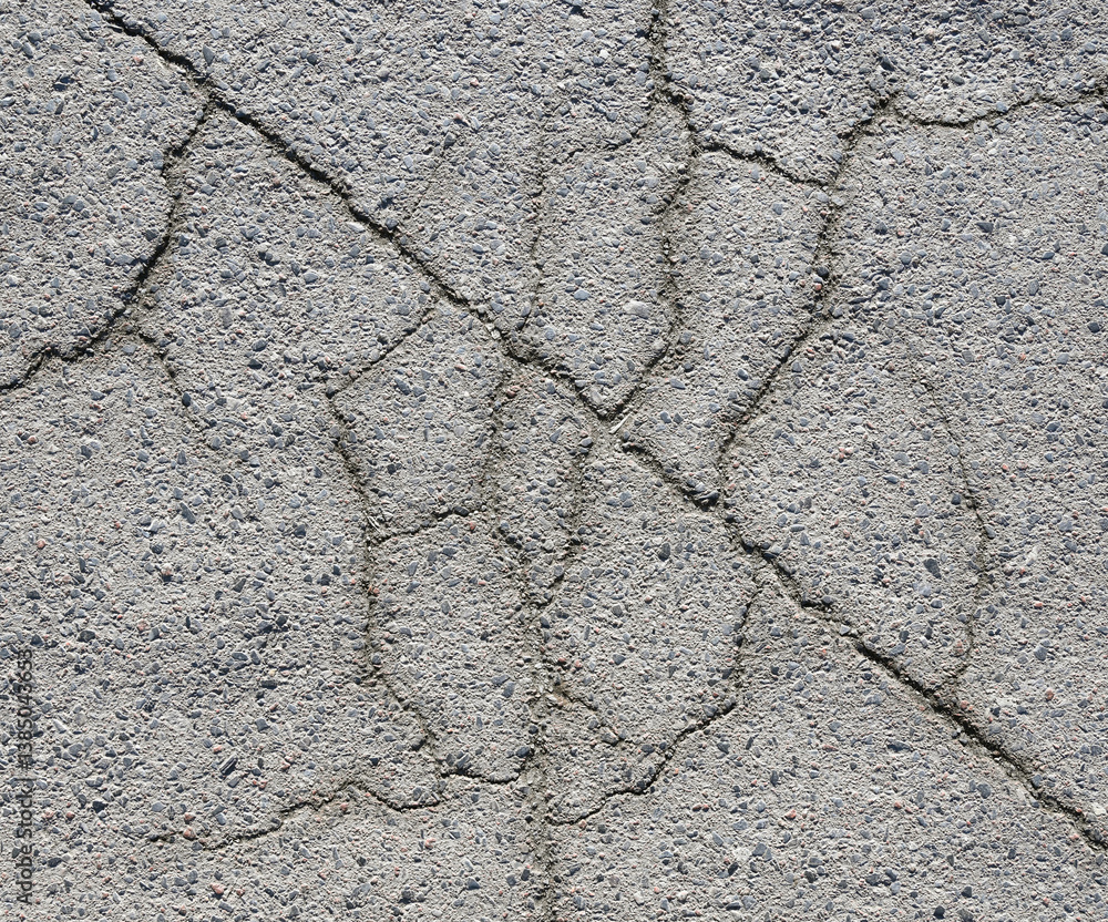 Concrete surface with intricate cracking patterns captured during midday in an urban area