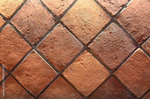 Obraz na płótnie Textured terracotta tiles arranged in a diamond pattern displayed indoors, showcasing an earthy color palette w salonie