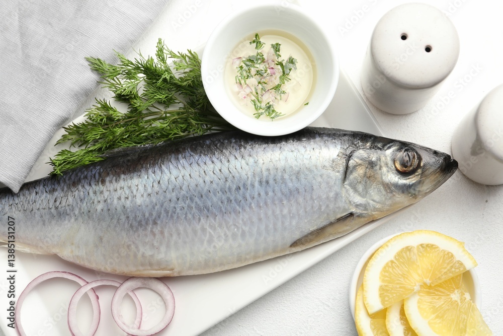 Salted herring and spices on white table, flat lay Salted herring and spices on white table, flat lay