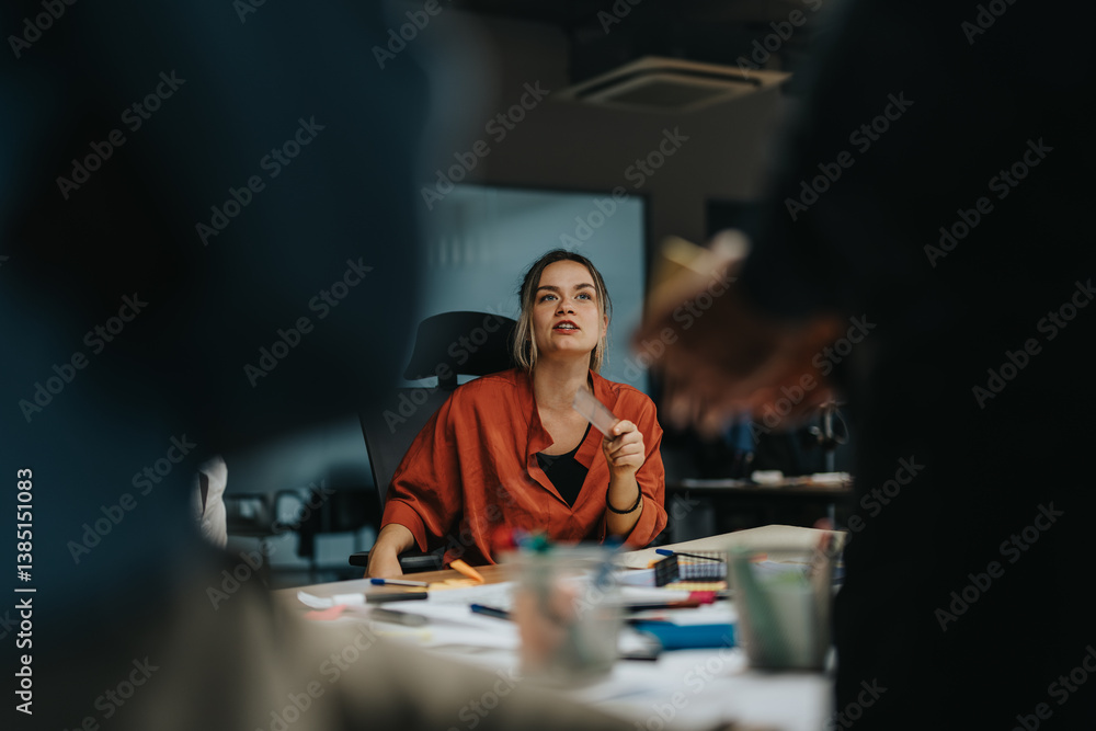 Colleagues brainstorm solutions in a collaborative office setting, analyzing and discussing project ideas to meet tight deadlines. A diverse team actively engages in a late evening strategy session.