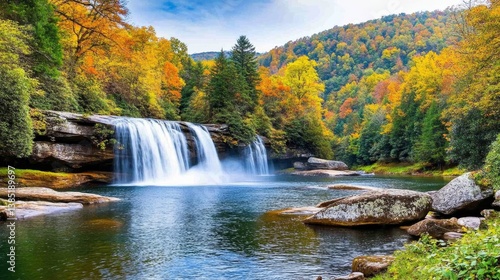 A gorgeous waterfall in the Smoky Mountains, surrounded by autumn trees and misty peaks