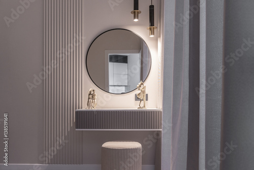 Dressing table for makeup. Modern dressing table with mirror with illumination. design of modern room with soft lighting. bedroom interior is decorated in beige shades. photos of interior.