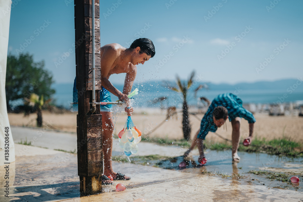 Two friends having fun with water balloons on the beach, embracing summer joy outdoors.