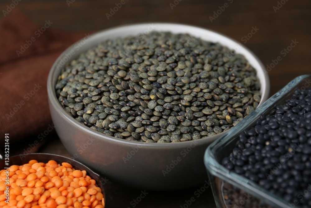 Obraz premium Different types of lentils on wooden table, closeup
