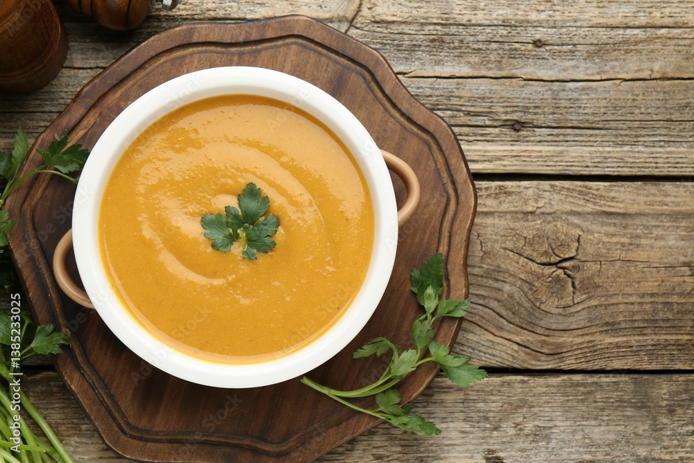 Delicious lentil cream soup with parsley on wooden table, top view Delicious lentil cream soup with parsley on wooden table, top view
