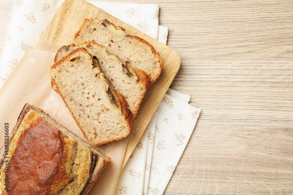 Cut banana bread on wooden table, top view. Space for text Cut banana bread on wooden table, top view. Space for text