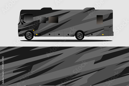 Sleek black and gray patterned RV parked on a smooth surface with a minimalist background