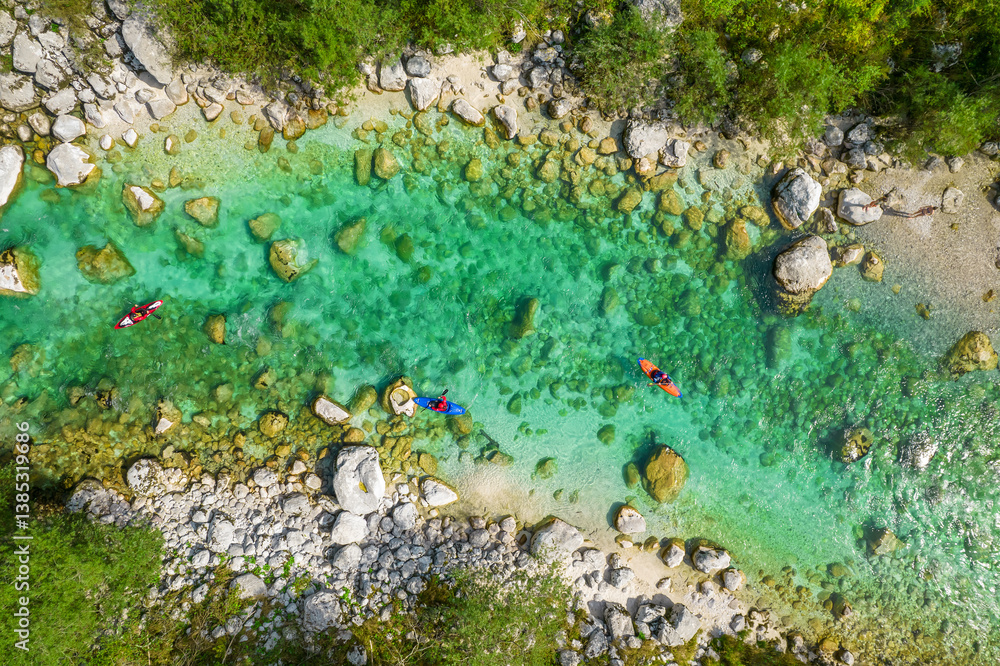 Kayakers on Soca river in Slovenia. Aerial top down tracking shot