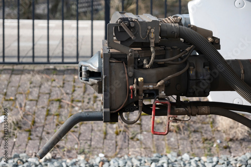 Close-up of a modern locomotive coupler of a regional train in the Netherlands. Railway coupler. Side view