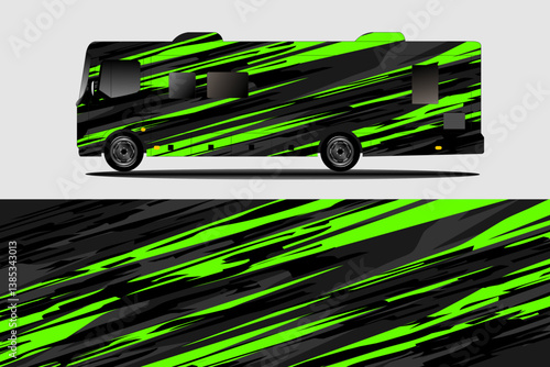 A sleek, modern RV with a striking green and black abstract design parked against a neutral backdrop