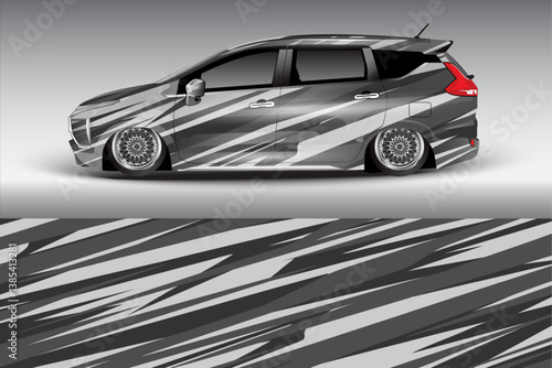 Sleek modified car with striking gray graphics, showcased against a minimalist gradient backdrop