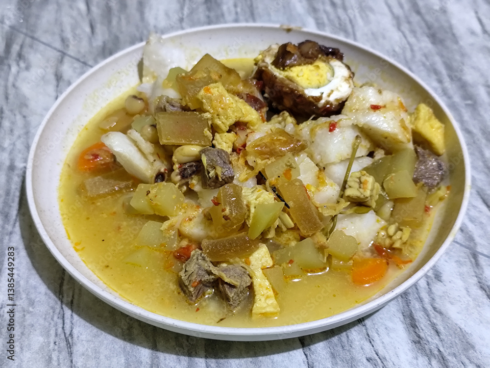 Ketupat Lebaran. Chicken vegetable ketupat is a typical Indonesian dish that is famous for its deliciousness and has a special place in Indonesian culinary culture Ketupat Lebaran. Chicken vegetable ketupat is a typical Indonesian dish that is famous for its deliciousness and has a special place in Indonesian culinary culture