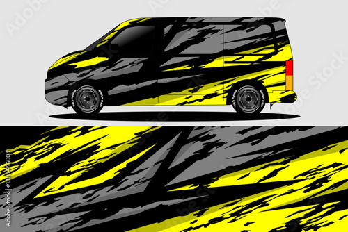 Stylishly designed van with bold black and yellow abstract patterns parked on a gray background
