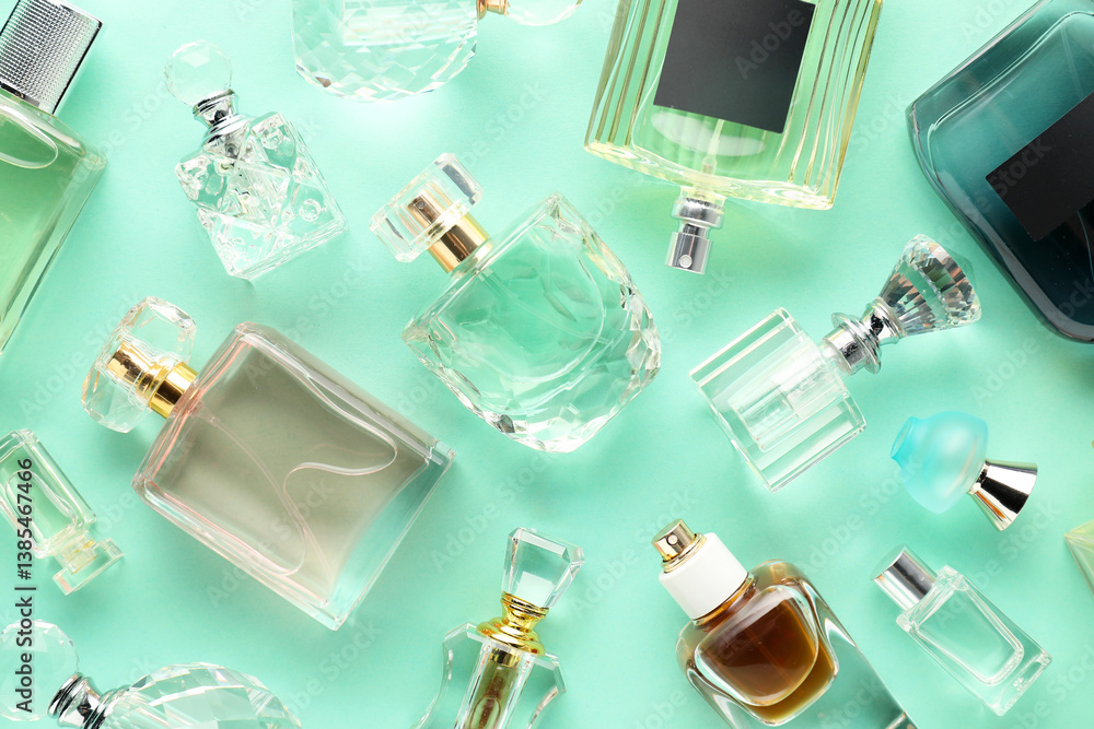Bottles of various perfumes on turquoise background, flat lay Bottles of various perfumes on turquoise background, flat lay
