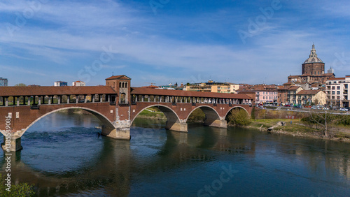 Obraz na płótnie Aerial view of Pavia and the Ticino River. View of the Cathedral of Pavia, Covered Bridge and the Visconti Castle. Lombardia, Italy
w salonie