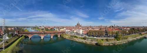 Obraz na płótnie Aerial view of Pavia and the Ticino River. View of the Cathedral of Pavia, Covered Bridge and the Visconti Castle. Lombardia, Italy
w salonie
