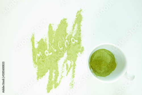 tea cup with white surface that has a noticeable yellow stains of matcha green tea on it. bright green color powder. ground powder of green tea specially processed from shade-grown