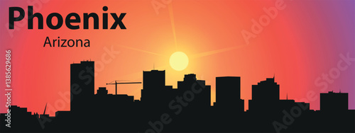 The black silhouette of the city of Phoenix, Arizona against the backdrop of a picturesque sunset