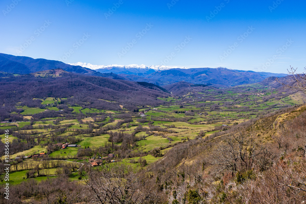 Fototapeta premium Panorama of Pic des Trois Seigneurs on the horizon and the Douctouyre Valley from the Ariège village of Roquefixade in spring