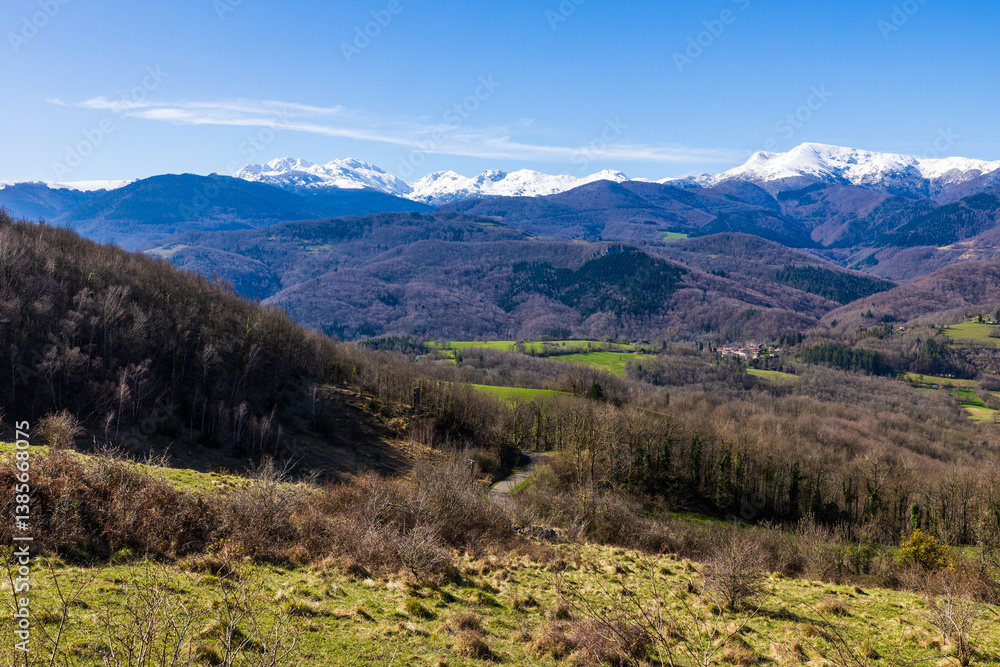 Panorama of the snowy Massif de Tabe with Mont Fourcat on the horizon and the Douctouyre Valley from the Ariège village of Roquefixade in spring Panorama of the snowy Massif de Tabe with Mont Fourcat on the horizon and the Douctouyre Valley from the Ariège village of Roquefixade in spring