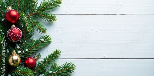 Fir branches and snowfall on a wooden white background with Christmas decorations, winter, winter wonderland