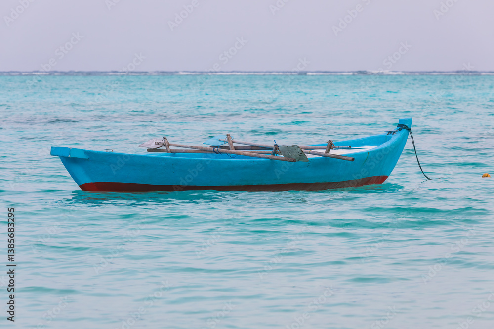 Naklejka premium Fishing boat on the shore of the Indian Ocean