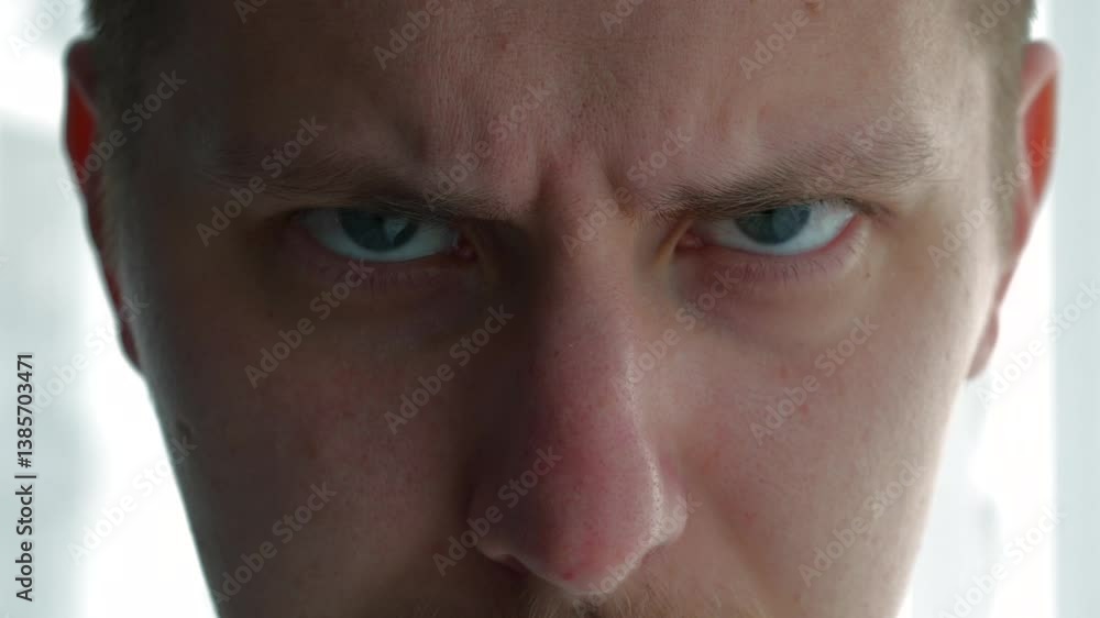 A man with an angry expression.
Angry and aggressive facial expressions on a person's face.
Wrinkles on the face.
Mimic wrinkles on the forehead and bridge of the nose in a person A man with an angry expression.
Angry and aggressive facial expressions on a person's face.
Wrinkles on the face.
Mimic wrinkles on the forehead and bridge of the nose in a person