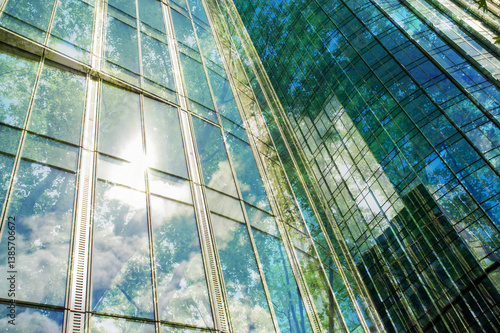 Obraz na płótnie Double exposure of modern buildings and lush trees, low angle view w salonie