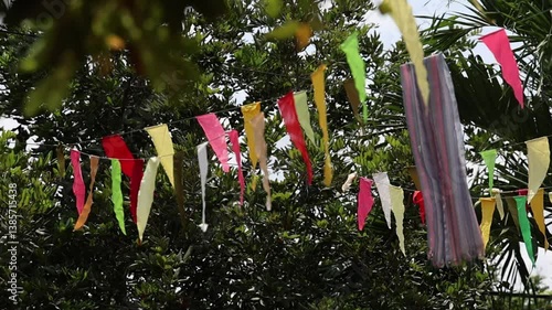 Colorful Triangle Flags Dancing in the Breeze Against a Clear Sky