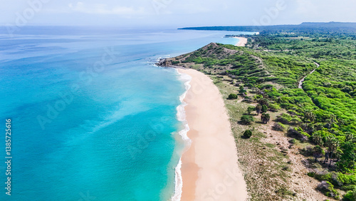 Fototapeta Naklejka Na Ścianę i Meble -  Exotic tropical beach with soft white sand and shimmering turquoise water meeting gentle waves.