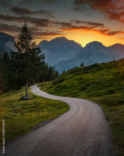 Lonely road in Switzerland mountains, during sunset