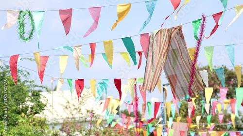 Colorful Triangle Flags Dancing in the Breeze Against a Clear Sky