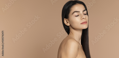 Haircare and female beauty. Portrait of young sensual woman with long dark hair, glazy donut skin, eyes closed, has dreamy look. Concept of spa, skincare and dermatology