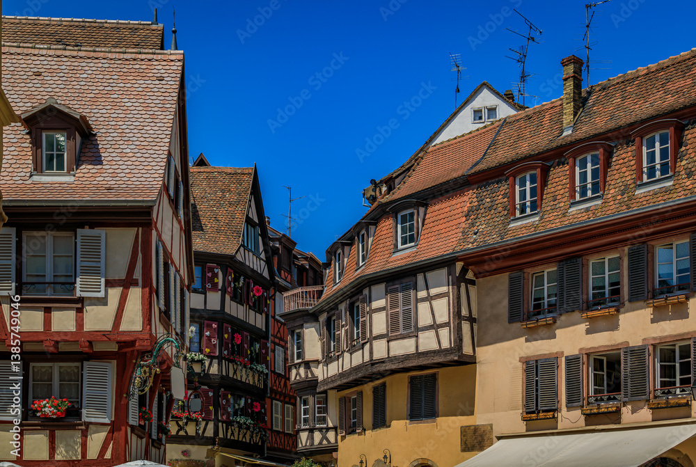 Fototapeta premium Ornate traditional half timbered houses with blooming flowers along the canals, Little Venice district in Colmar, picturesque village in Alsace France