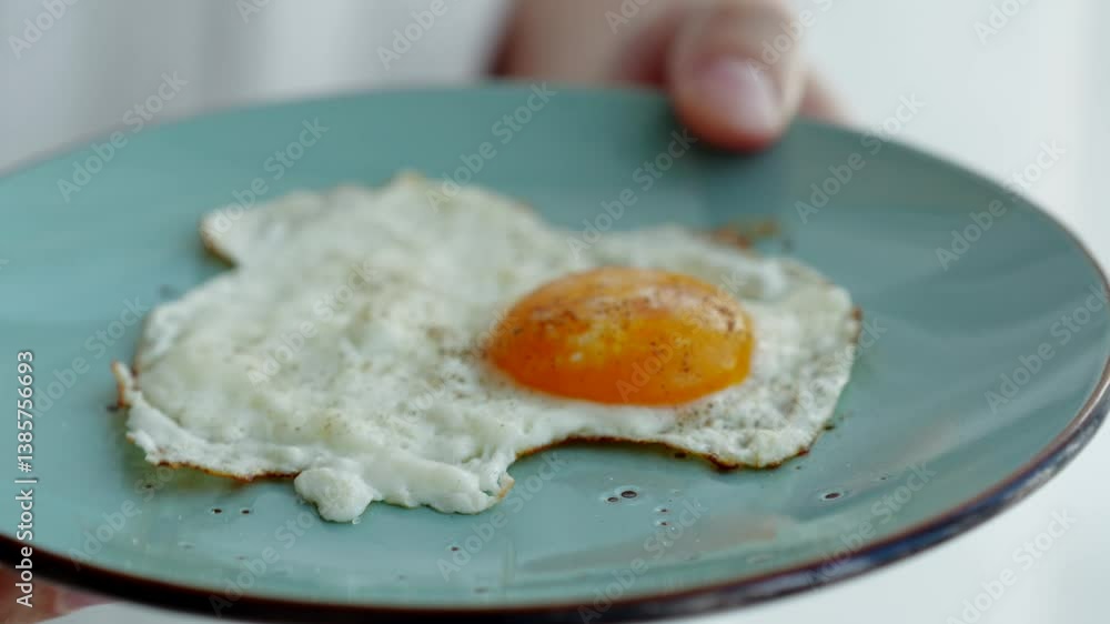 Fried egg on a blue plate.
A man with a fork and a fried egg.
Healthy food.
Fried egg for breakfast. Fried egg on a blue plate.
A man with a fork and a fried egg.
Healthy food.
Fried egg for breakfast.