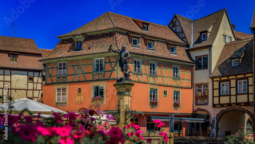Obraz na płótnie Ornate half timbered houses with blooming flowers near the Schwendi Fountain, Little Venice district in Colmar, picturesque village in Alsace, France w salonie