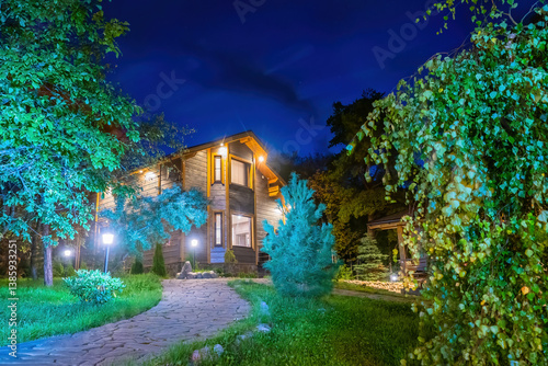 Two-story cottage in evenin...