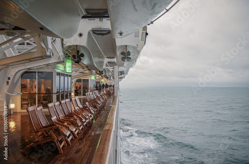 Obraz na płótnie Views onto wet outdoor teak balcony terrace veranda promenade boat deck of ocean liner cruiseship cruise ship with chairs and loungers at sea during w salonie