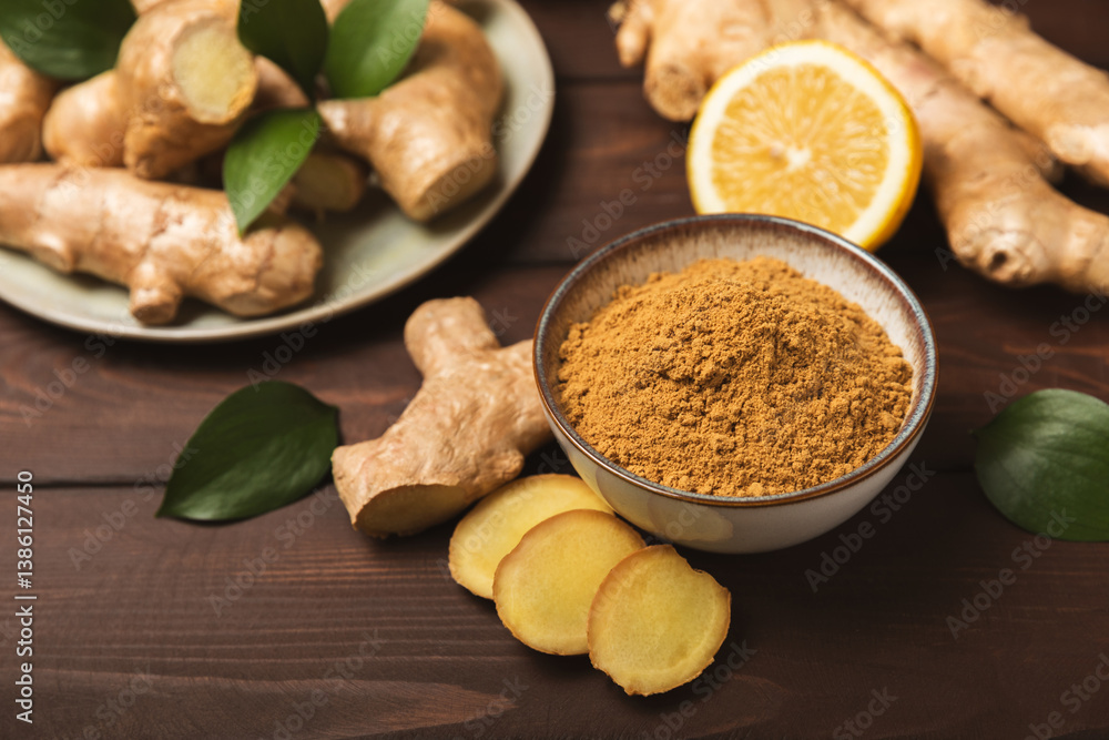 Fototapeta premium Fresh ginger on wooden background. Dry ginger. Sliced ​​ginger with honey and lemon. Ginger root. Traditional alternative medicine, healing tea for immunity. Seasoning and spices concept. Copy space.