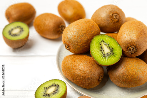 Kiwi on wooden background. Whole fruit and slices pieces of green kiwi on table. fresh ripe juicy kiwi. Tropical fruit. Organic fruit. Healthy eating. Space for text. Copy space