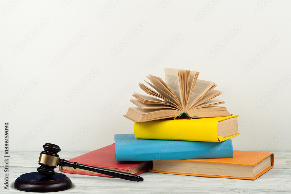 Law concept open book with wooden judges gavel on table in a courtroom or law enforcement office, white background. Copy space for text. Law concept open book with wooden judges gavel on table in a courtroom or law enforcement office, white background. Copy space for text.
