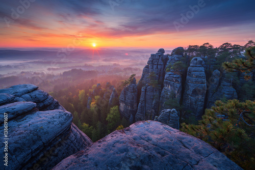 Obraz na płótnie Sunrise on top of mountains, pine trees, foggy valley below, colorful sky, beautiful landscape with mountains w salonie