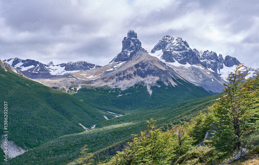 Naklejka premium A landscape of Estero Parada Valley in a way to the camping Neozelandes in the Cerro Castillo National Park. Cerro Palo and Cerro Chocolate loom in the background. Tourism along the Carretera Austral.