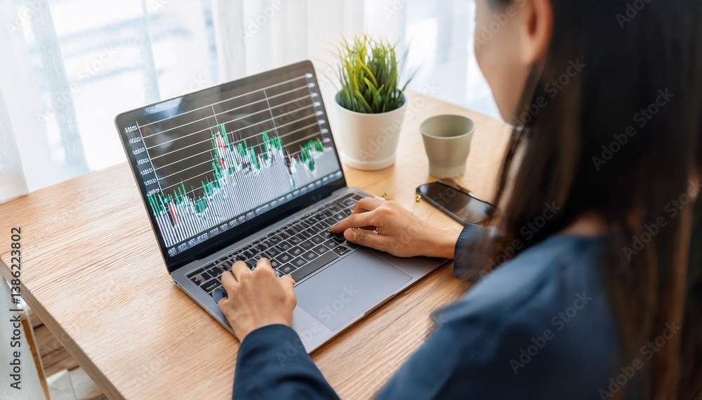 Person analyzing stock charts in a notebook Person analyzing stock charts in a notebook