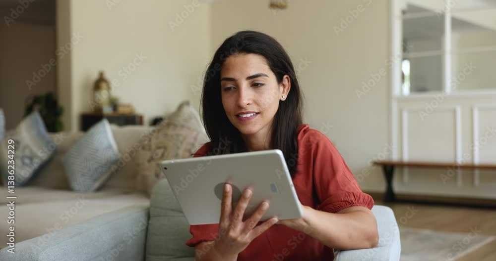 Happy young Hispanic woman using web service on digital tablet for communication, browsing Internet, social medial, chatting, smiling laughing, enjoying smart technology Happy young Hispanic woman using web service on digital tablet for communication, browsing Internet, social medial, chatting, smiling laughing, enjoying smart technology