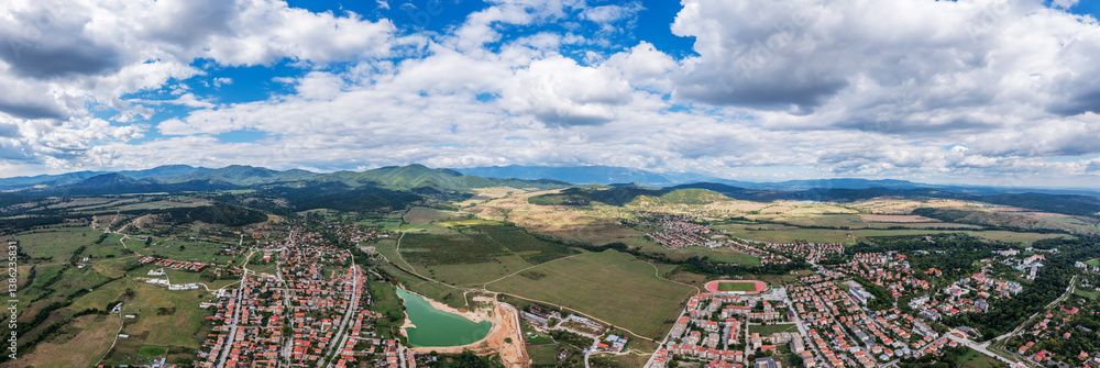 Panoramic aerial view of a mountain town under rolling hills