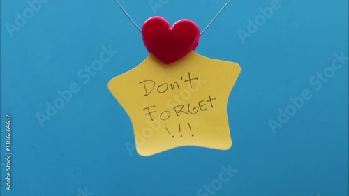 Heart holding a sticky note with a don't forget phrase