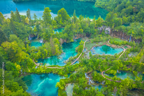 A breathtaking drone photo of the Plitvice Lakes showing vibrant turquoise lakes, lush greenery, and cascading waterfalls in one of the most popular tourist destinations in Croatia