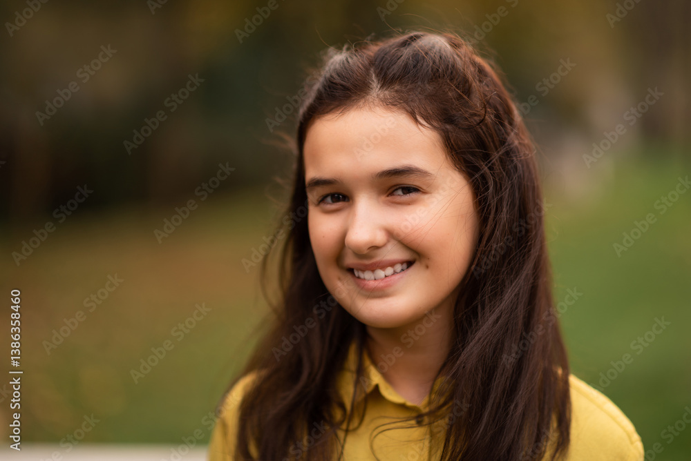 Close up portrait of a happy teenage girl outside, looking at the camera and smiling. Close up portrait of a happy teenage girl outside, looking at the camera and smiling.